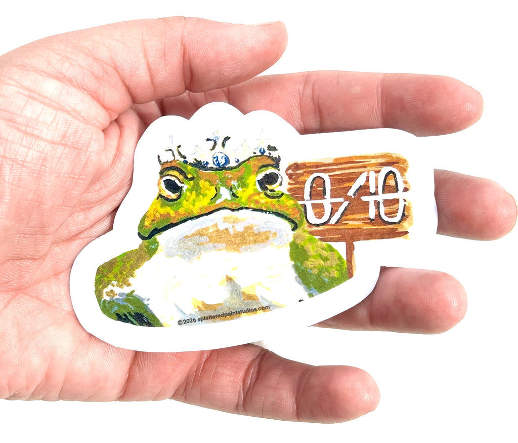 0/10 3-inch vinyl frog sticker held in hand to show size and scale