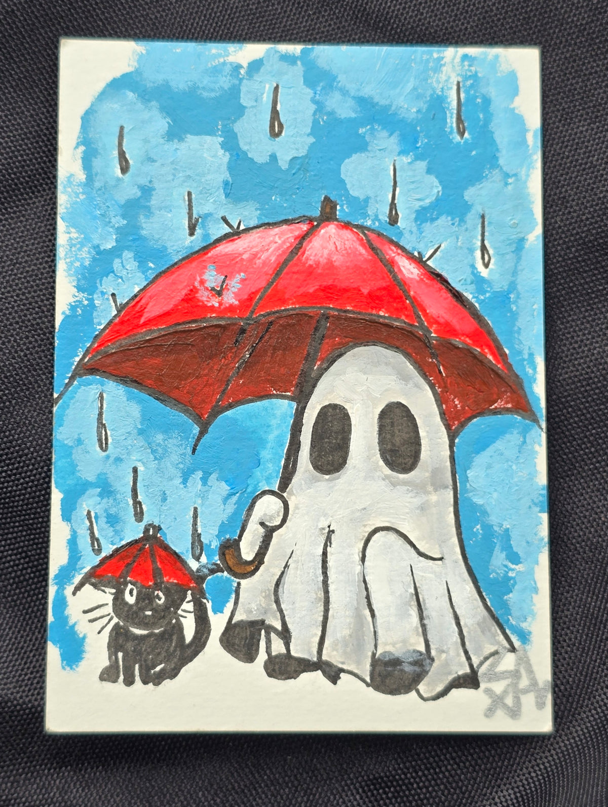 A Little Under the Weather original miniature painting of a white ghost and black kitty carrying red umbrellas in the rain against a bright blue sky.