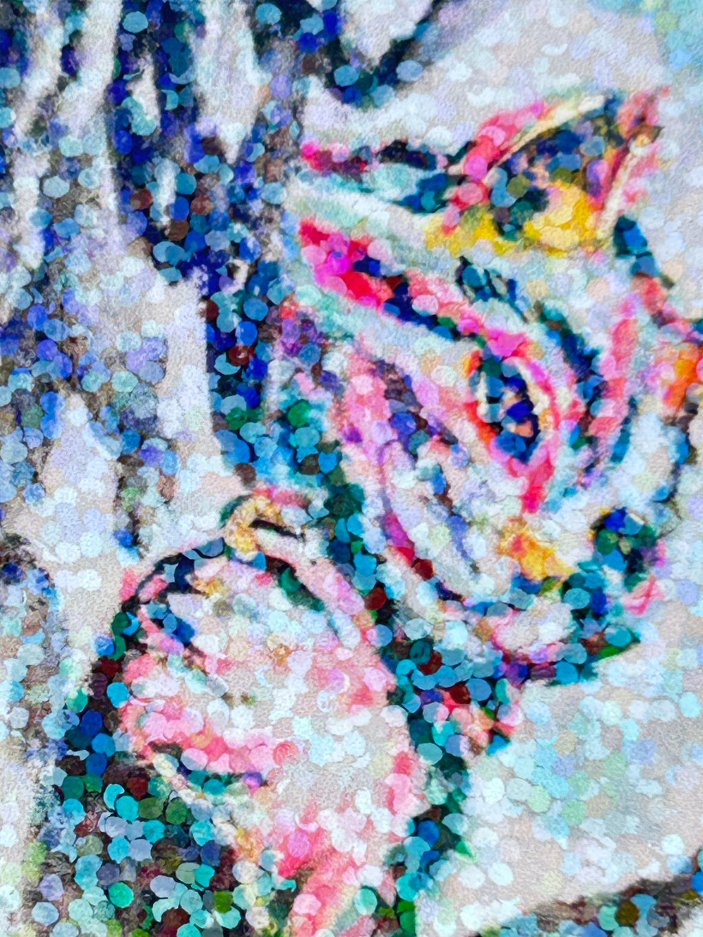 Close-up detail of Between The Branches cat sticker showing colorful pink, blue, and teal artwork