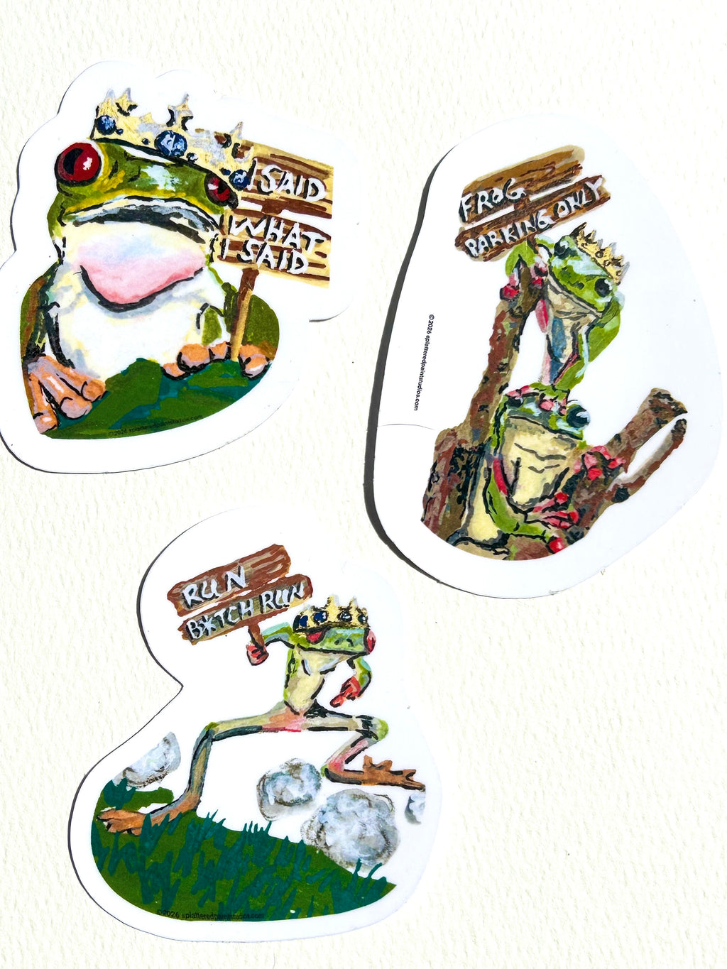 Three vinyl stickers featuring crowned frogs from the Chronicles of a Tired Frog collection