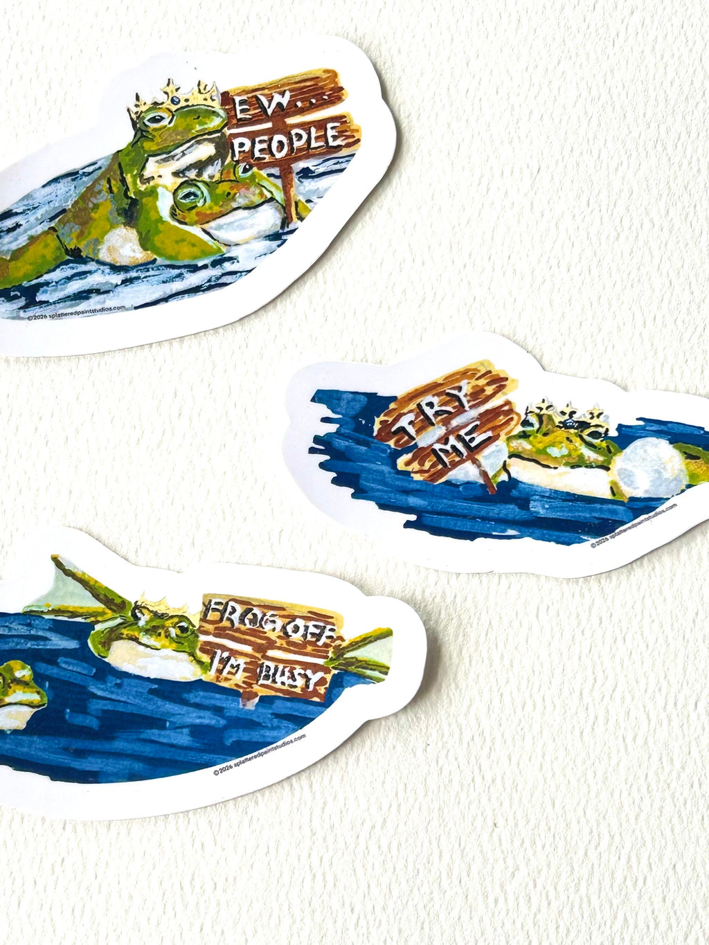 Three vinyl frog stickers from the Chronicles of a Tired Frog collection (Ew..People, Try Me, and Frog Off I'm Busy)