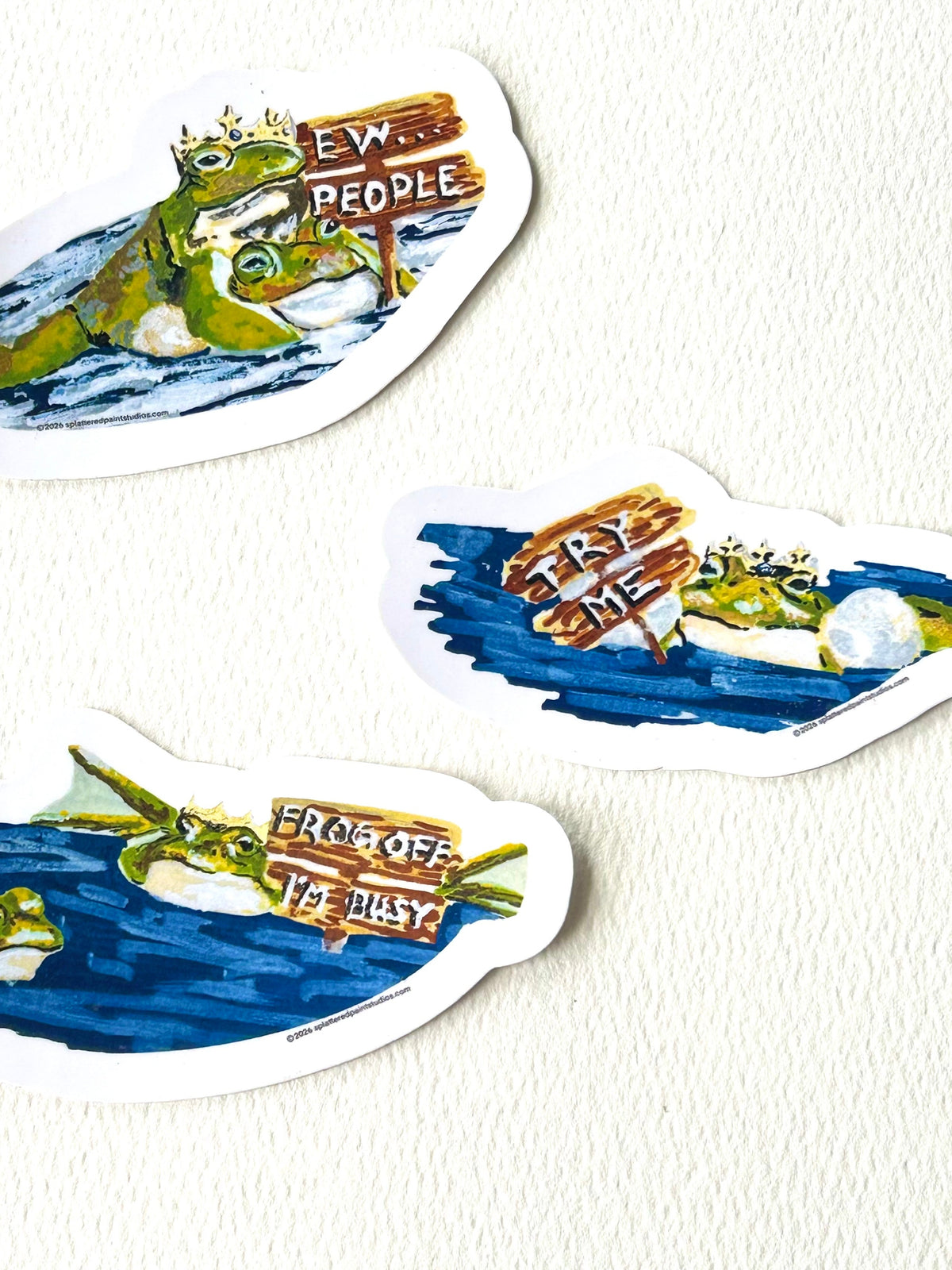 Three vinyl frog stickers from the Chronicles of a Tired Frog collection (Ew..People, Try Me, and Frog Off I'm Busy)