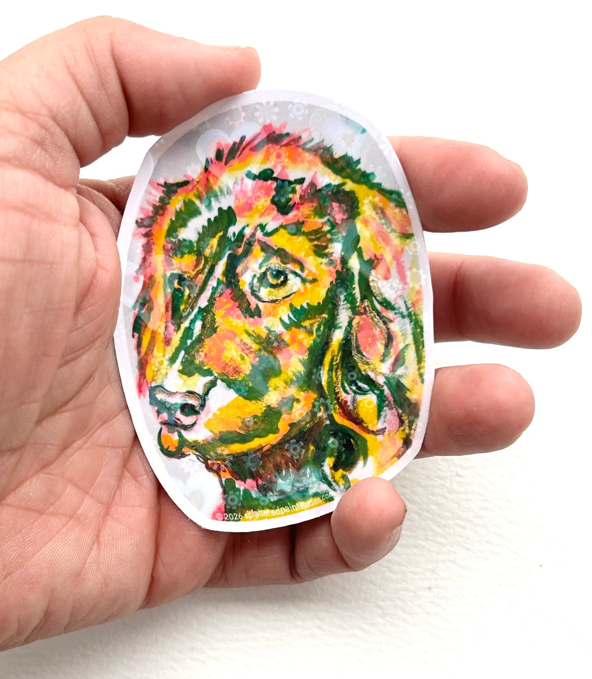Devotion 3-inch holographic vinyl dog sticker held in hand to show size and scale