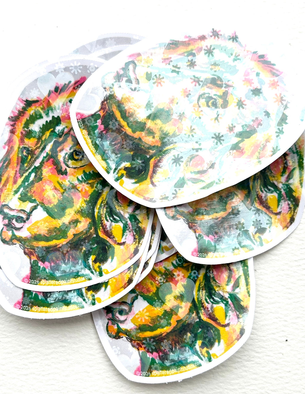Stack of Devotion holographic vinyl stickers featuring colorful dog artwork from the Neon Familiars collection