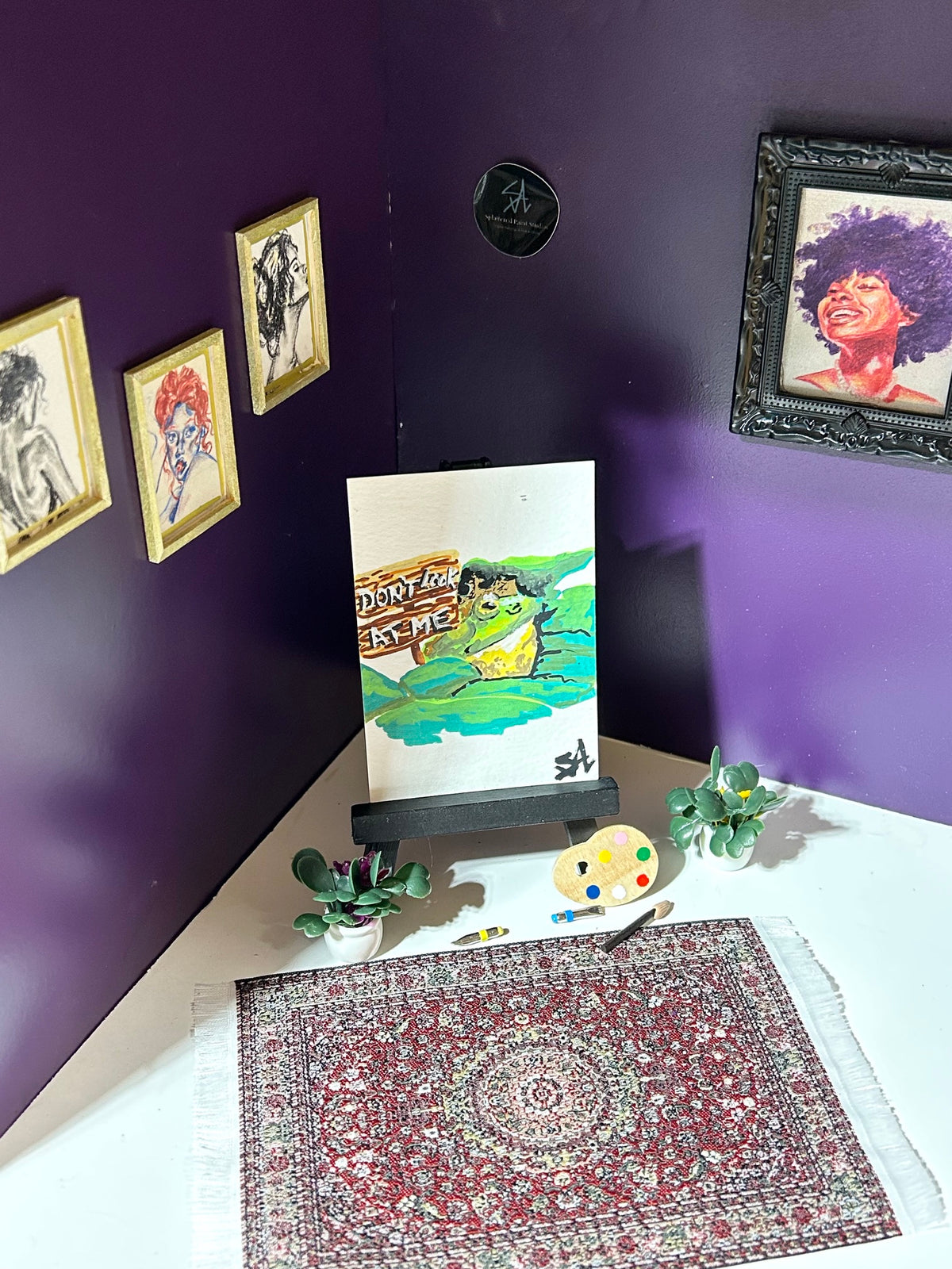 Don't Look At Me miniature frog artwork displayed in an art room