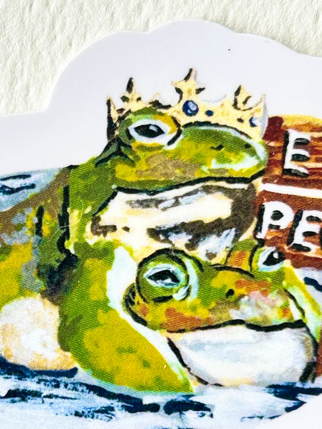 Close-up of Ew...People vinyl sticker showing two expressive green frogs, including one wearing a crown