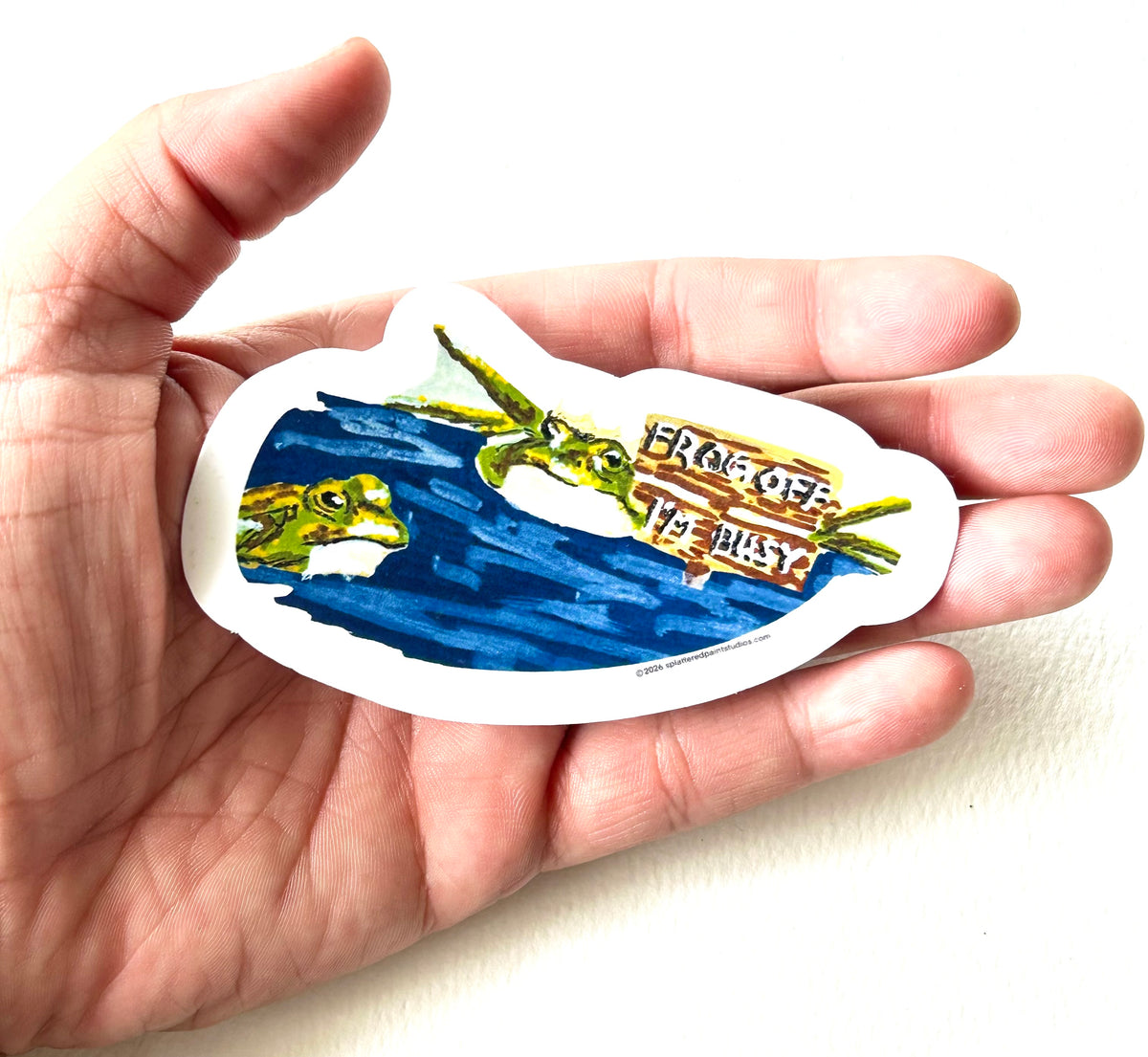 Frog Off I'm Busy 3-inch vinyl sticker held in hand to show size and scale