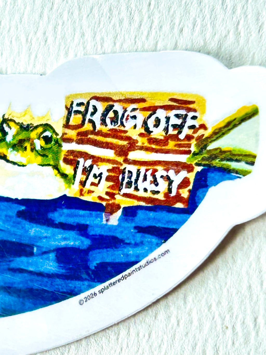 Close-up of Frog Off I'm Busy vinyl sticker showing the crowned frog and Frog Off I'm Busy sign