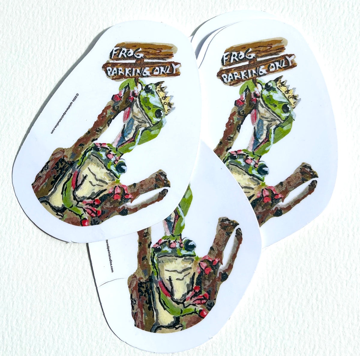 Stack of Frog Parking Only vinyl stickers featuring two crowned frogs perched on branches