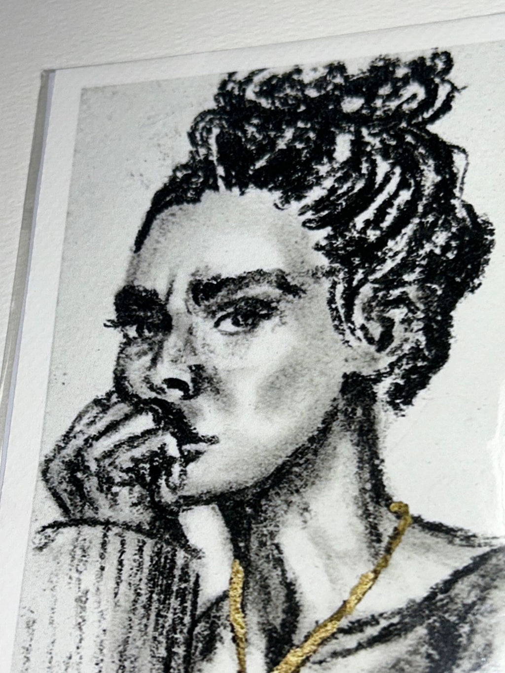 Close-up of Golden Defiance charcoal portrait print showing expressive black marks and metallic gold accents