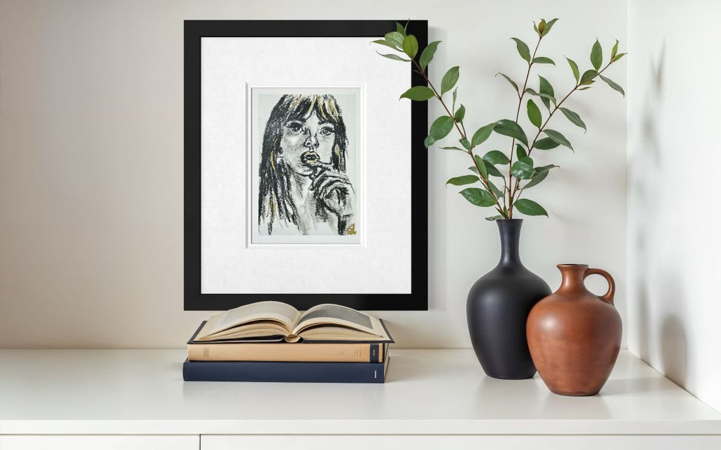 Golden Kiss 5x7 charcoal art print with gold accents displayed framed above books and decorative vases