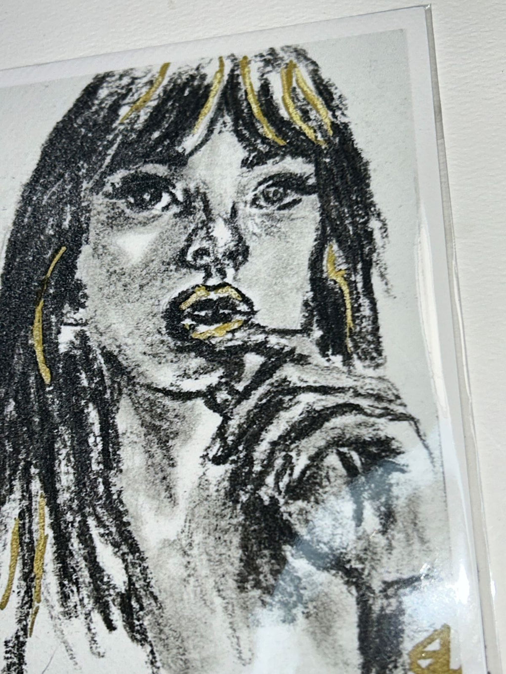 Close-up of Golden Kiss charcoal portrait print showing expressive black marks and metallic gold accents