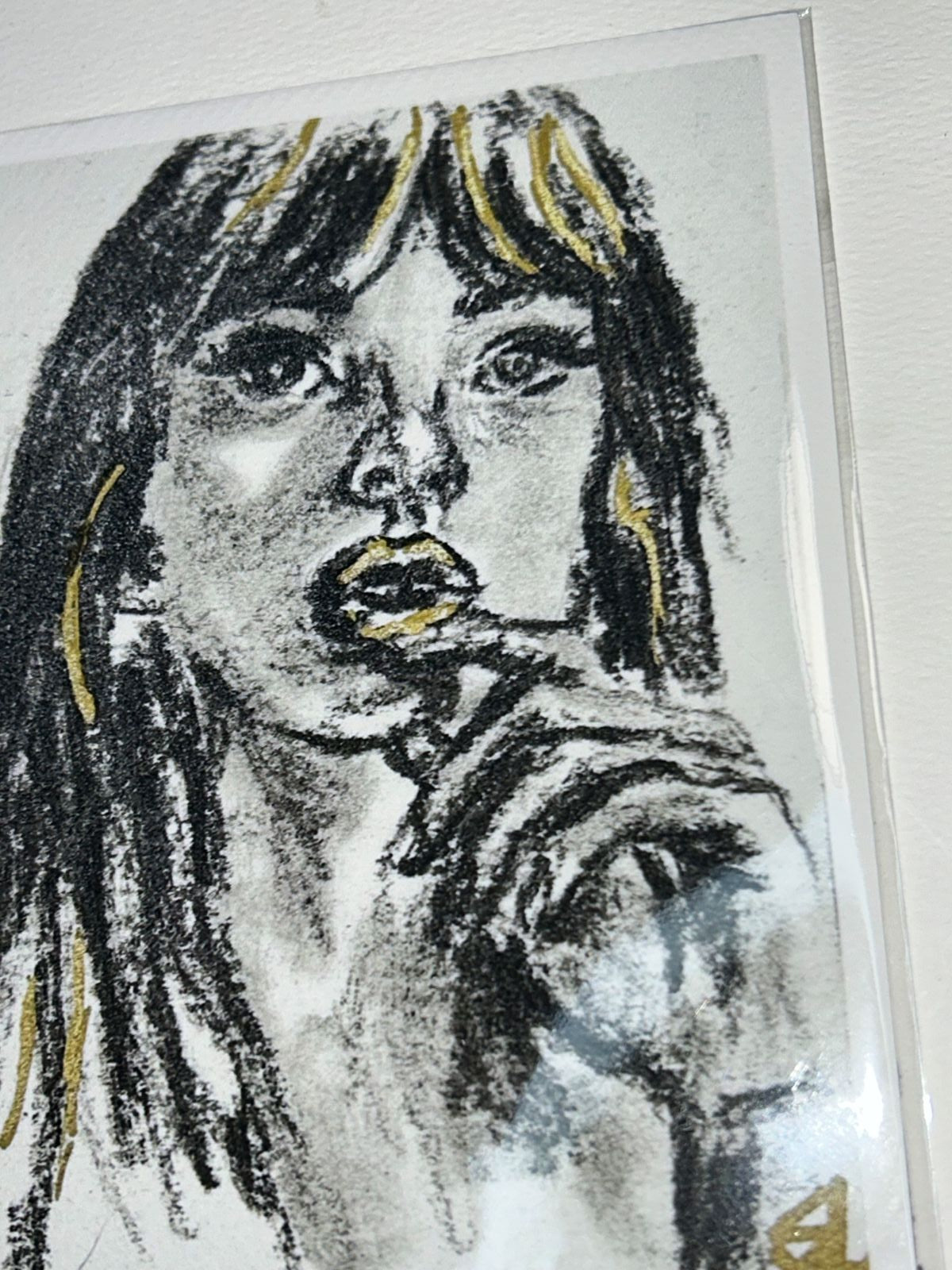 Close-up of Golden Kiss charcoal portrait print showing expressive black marks and metallic gold accents