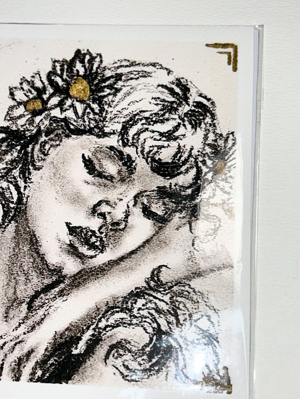 Close-up of Golden Lullaby charcoal portrait print showing floral details and metallic gold accents
