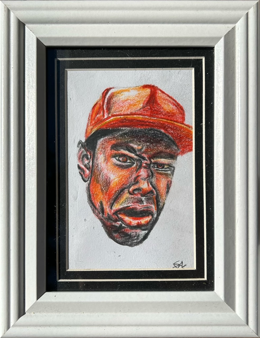 Hardline original colored pencil portrait featuring a man in a red cap, matted and displayed in a 5x7 frame