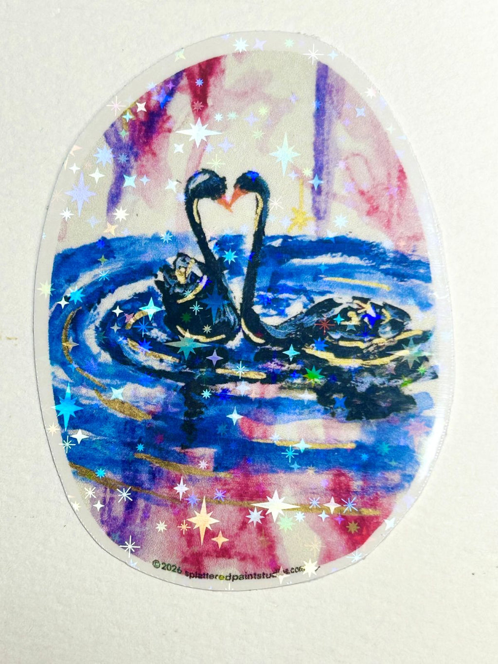 Heart of the Cosmos holographic vinyl sticker featuring two swans forming a heart surrounded by colorful stars