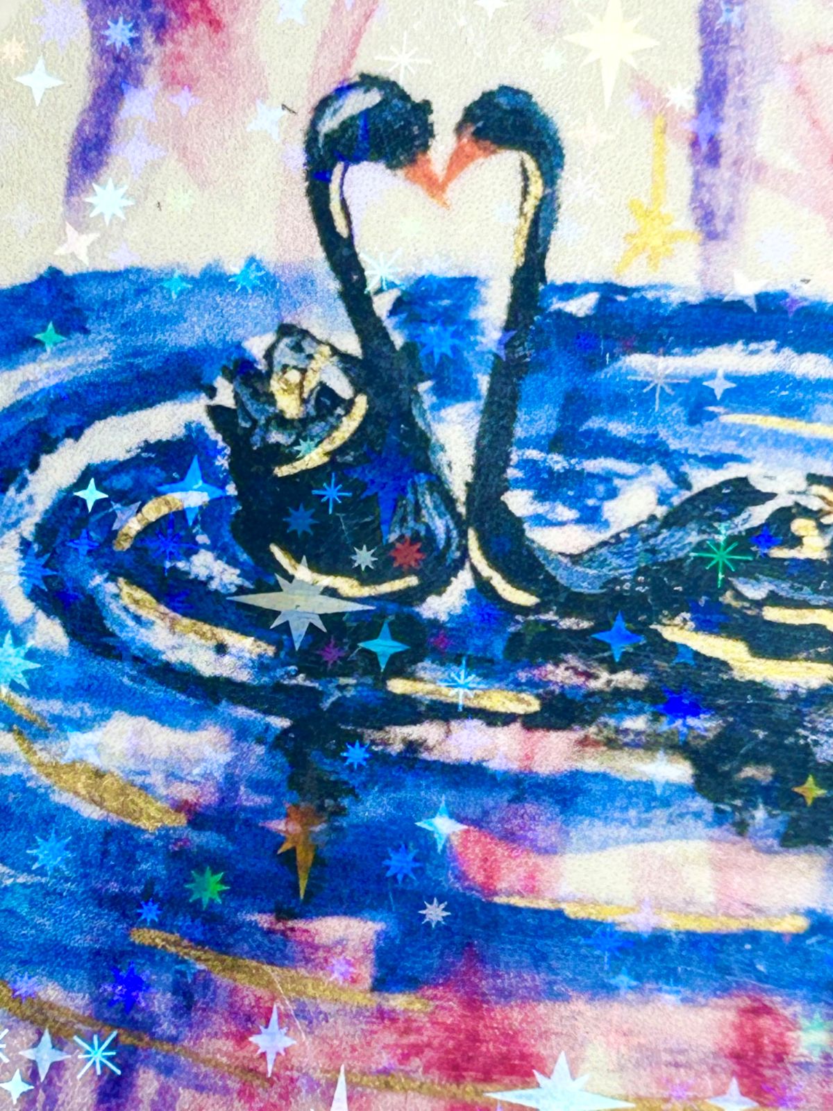 Close-up of Heart of the Cosmos holographic sticker showing two swans forming a heart with celestial star details