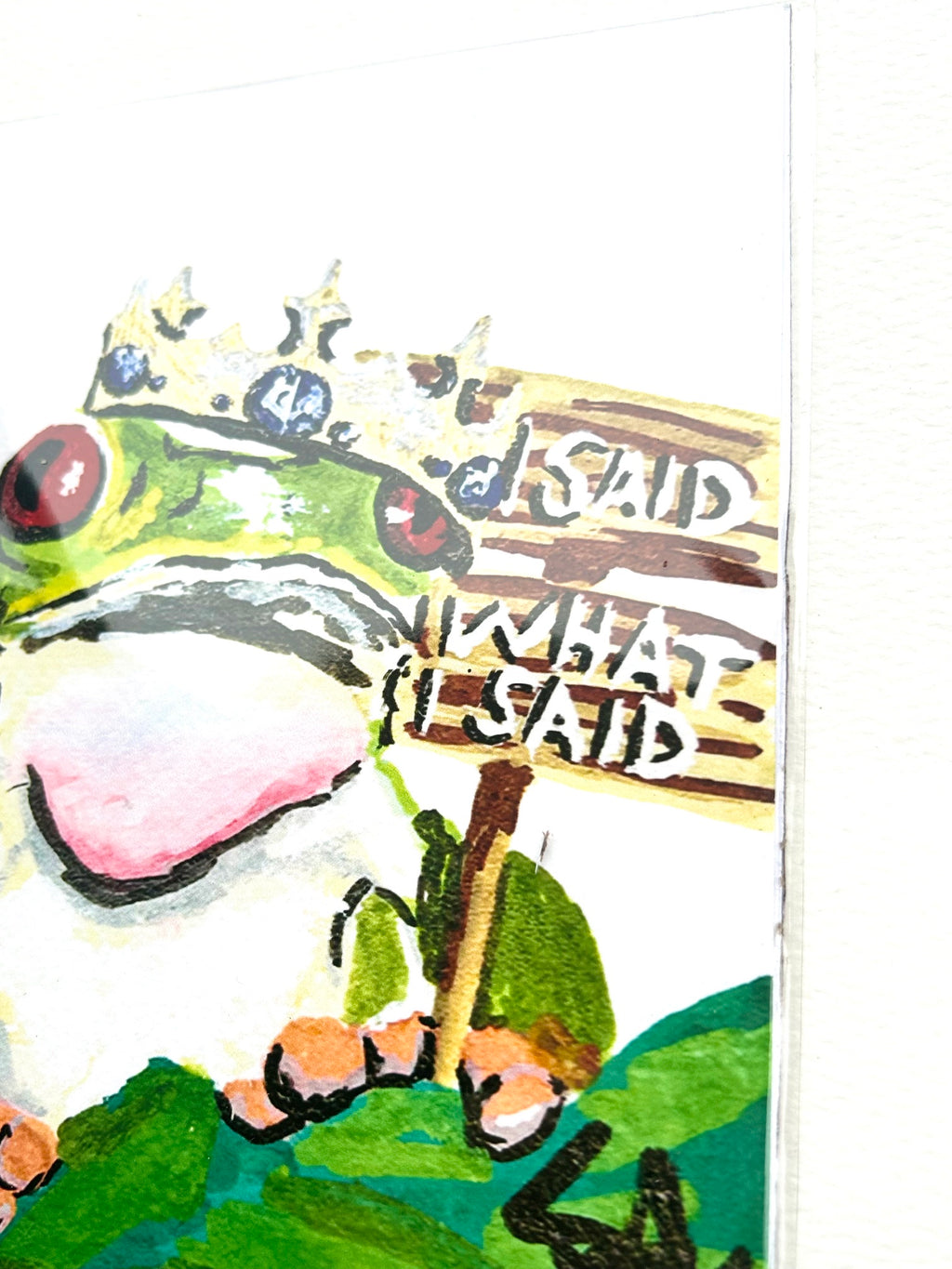 Angled detail of I Said What I Said 5x7 art print featuring a crowned frog holding a wooden sign