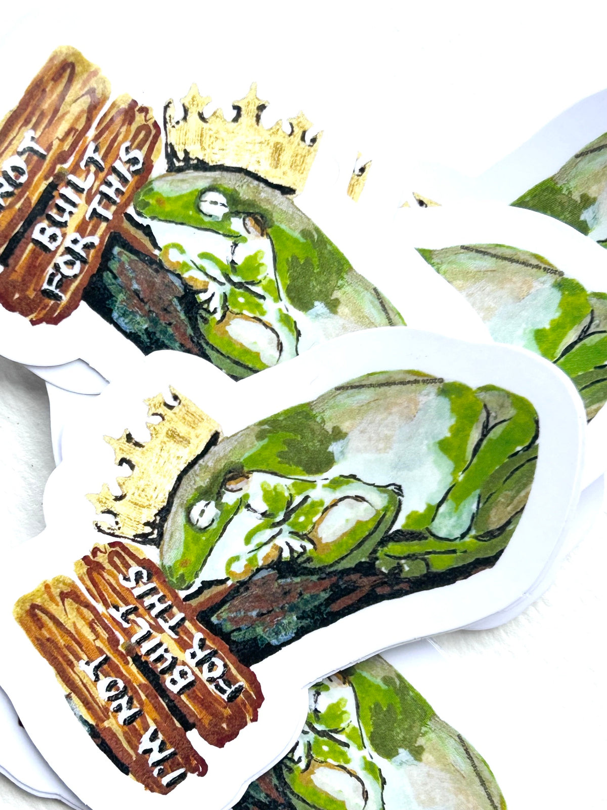 Group of I’m Not Built for This vinyl stickers featuring a tired green frog wearing a gold crown