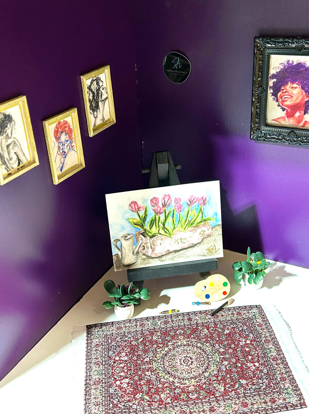 Just Because miniature floral artwork displayed in an art room