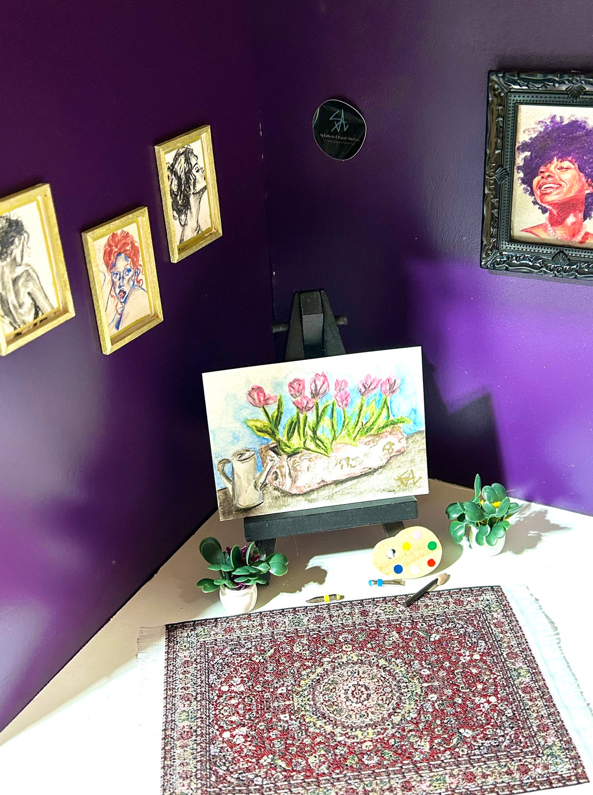 Just Because miniature floral artwork displayed in an art room