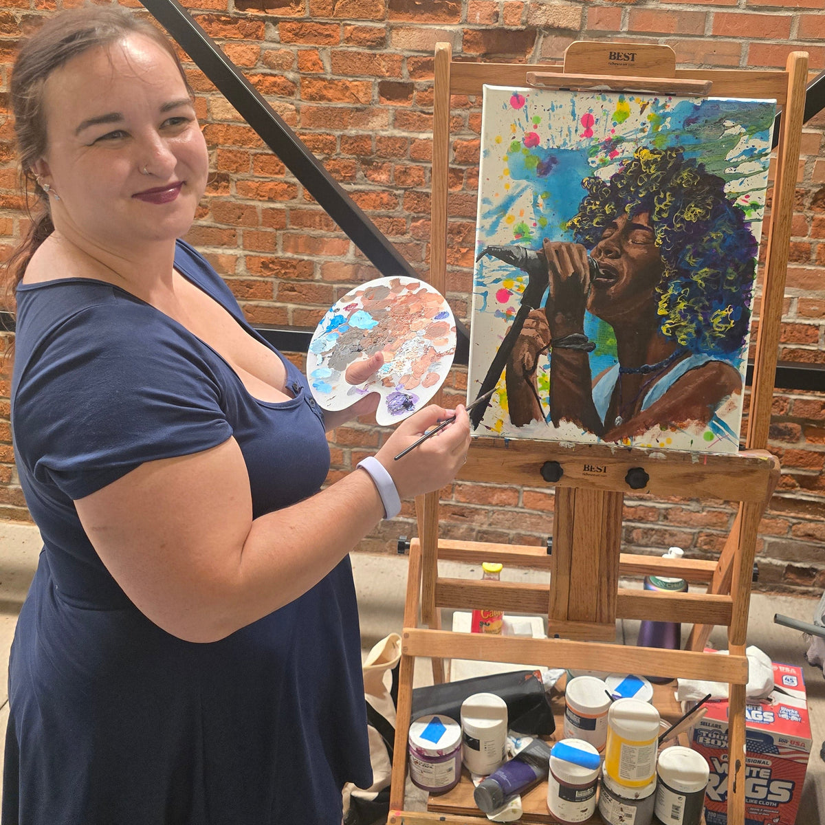 Artist creating a colorful portrait during a live painting event
