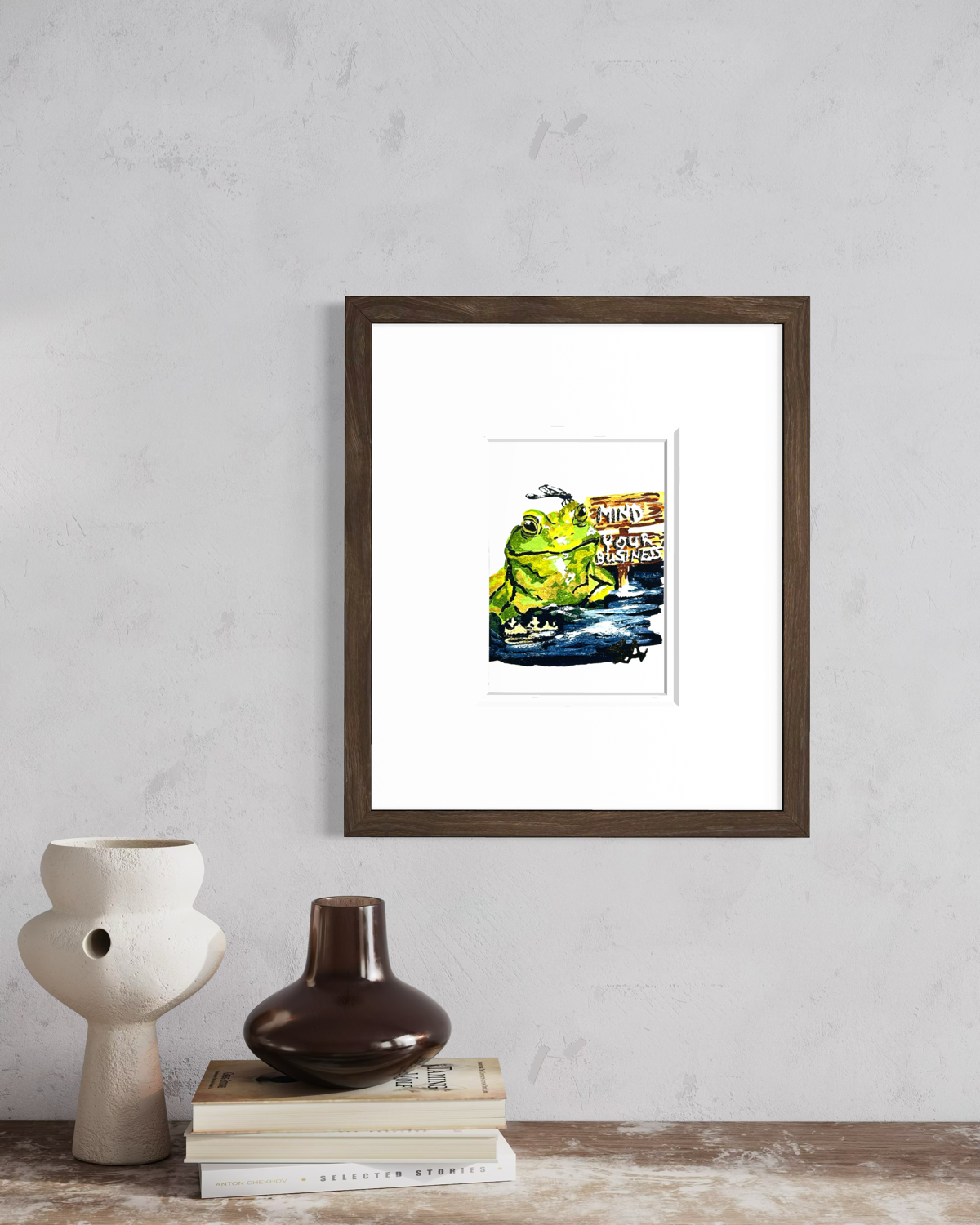 Mind Your Business 5x7 frog art print displayed in a brown frame on a neutral wall