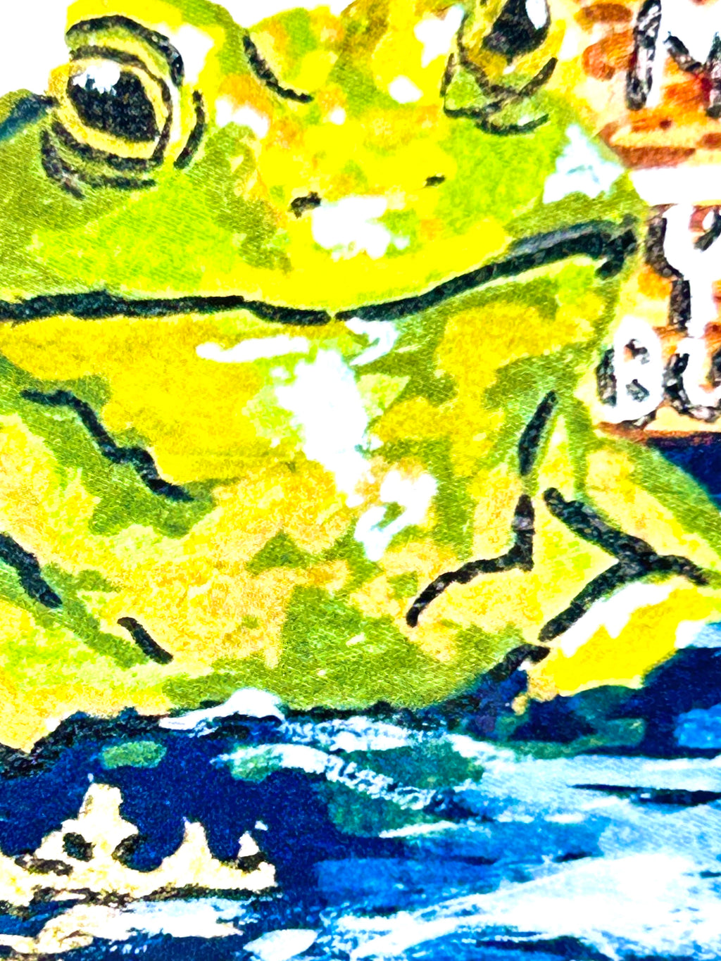 Close-up of Mind Your Business vinyl sticker showing the green frog artwork and painted water details