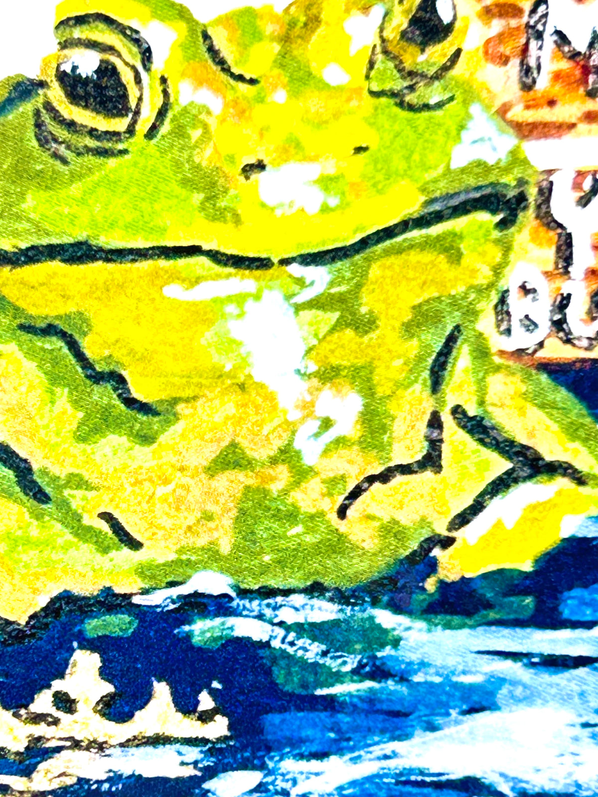 Close-up of Mind Your Business vinyl sticker showing the green frog artwork and painted water details