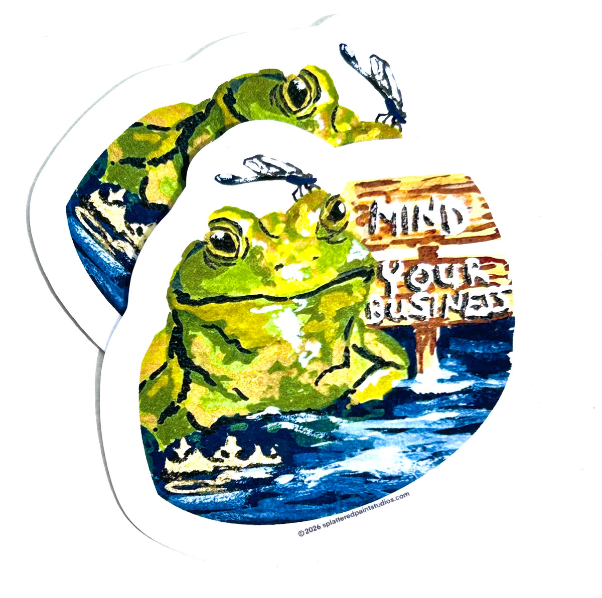 Stack of Mind Your Business vinyl stickers featuring a green frog in water with a dragonfly and wooden sign