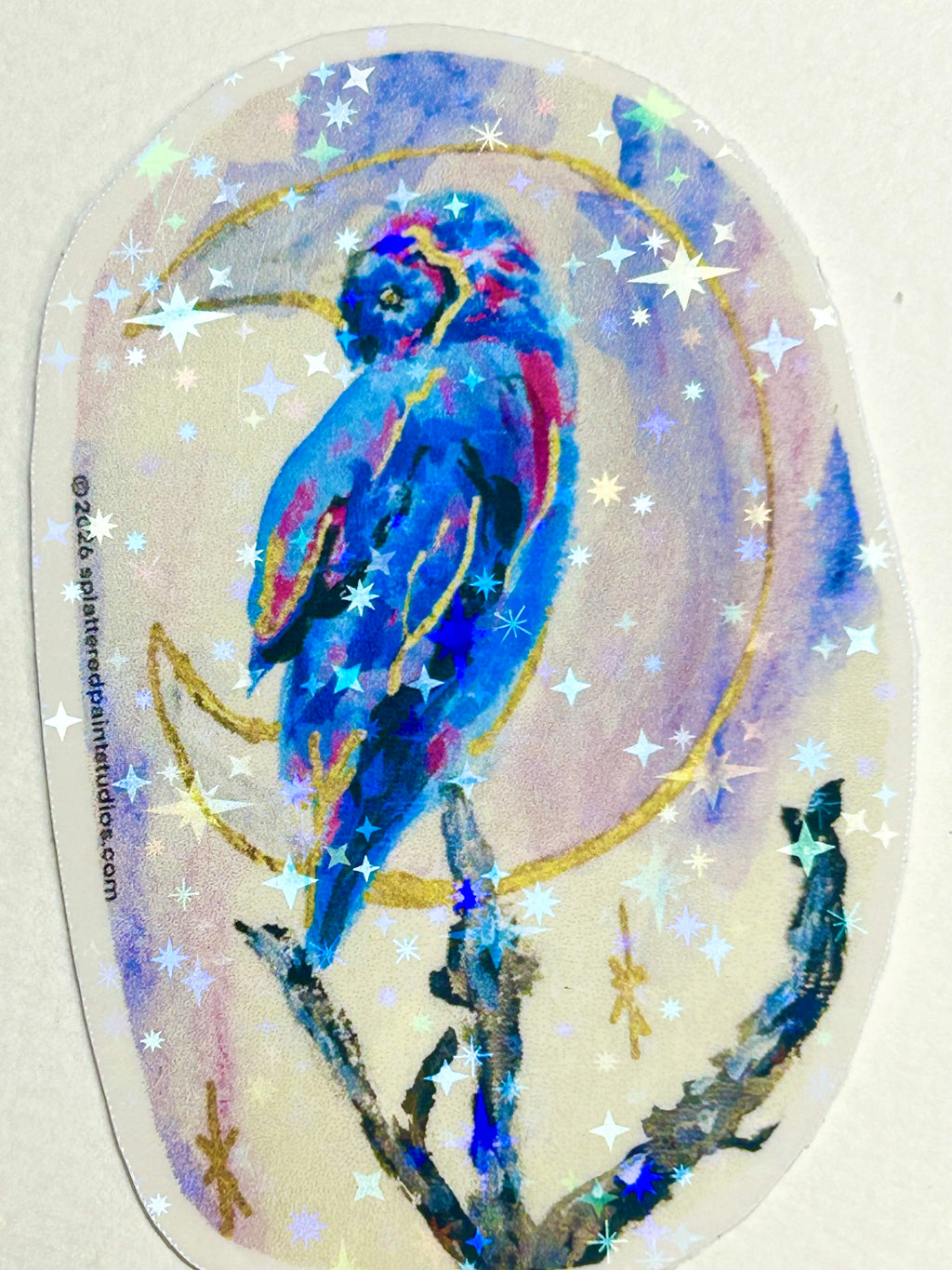 Moonbound Sentinel 3-inch holographic vinyl art sticker featuring a vivid blue bird surrounded by a crescent moon and reflective stars
