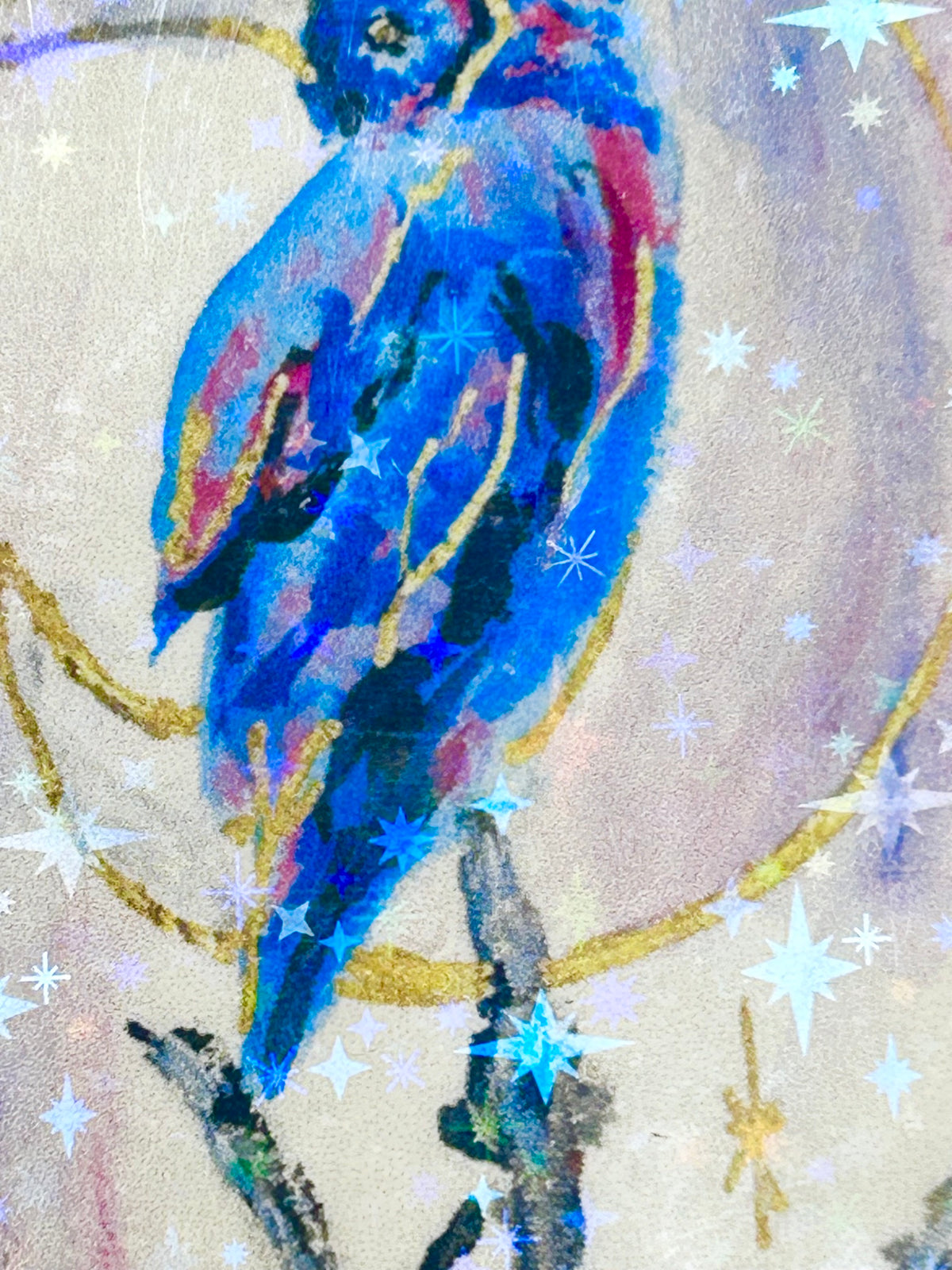 Close-up of Moonbound Sentinel holographic vinyl sticker showing a vivid blue bird with reflective star and gold moon details