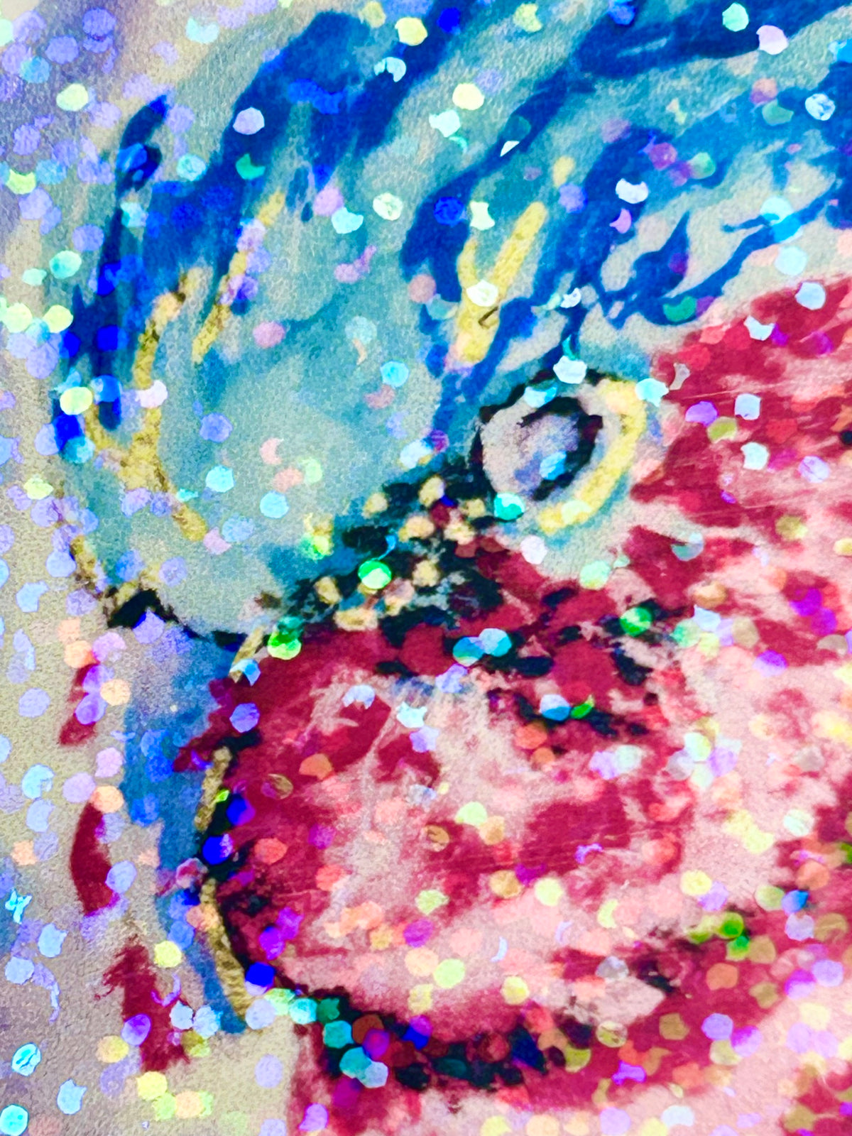 Close-up of Nebula Regent holographic vinyl sticker showing the vibrant pink and blue bird artwork and reflective glitter finish
