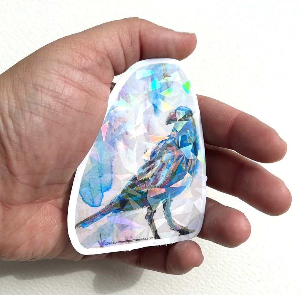 Nightflare 3-inch holographic vinyl art sticker held in hand to show size and scale