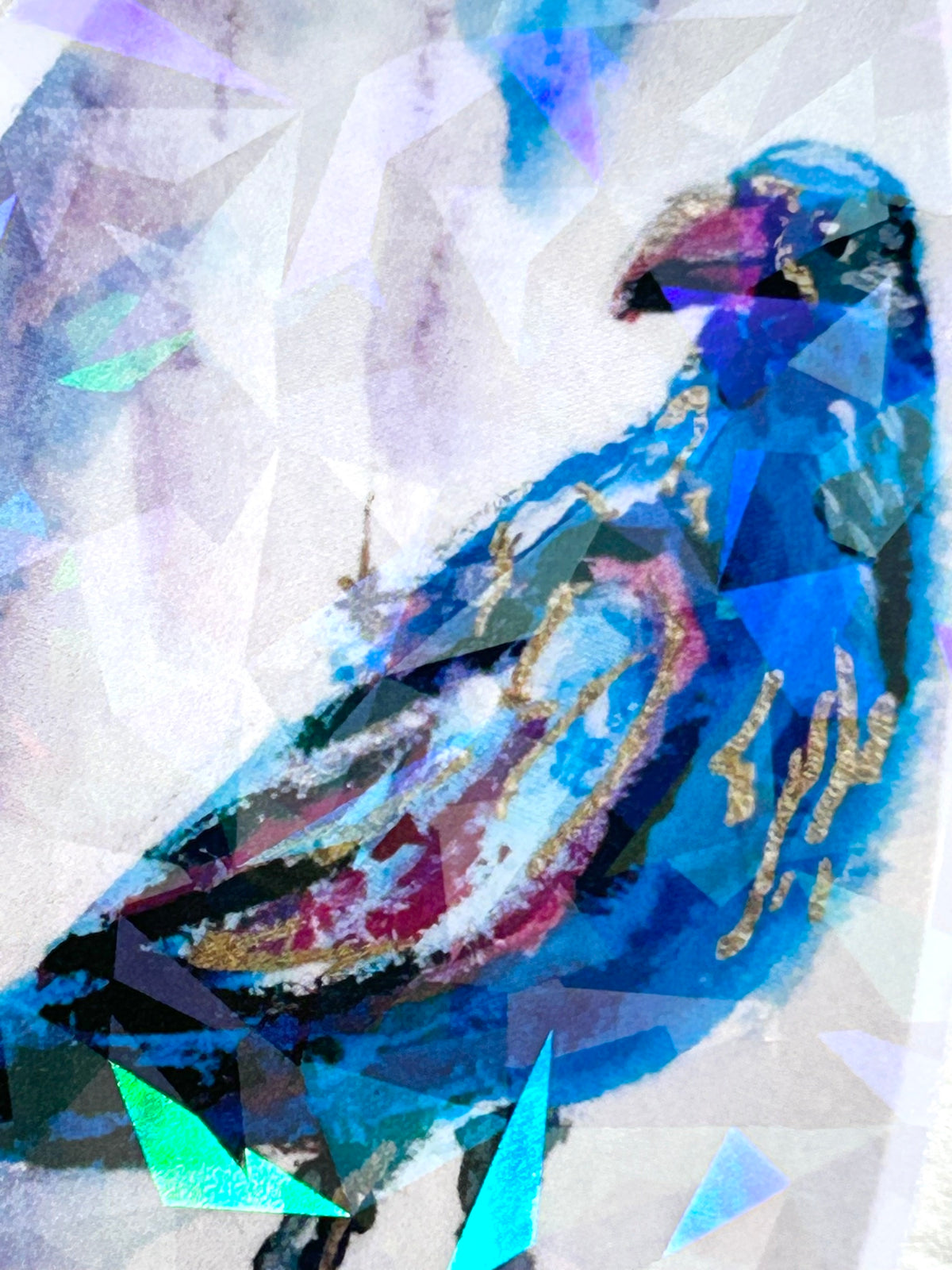 Close-up of Nightflare holographic vinyl sticker showing the blue and purple bird artwork with reflective geometric details