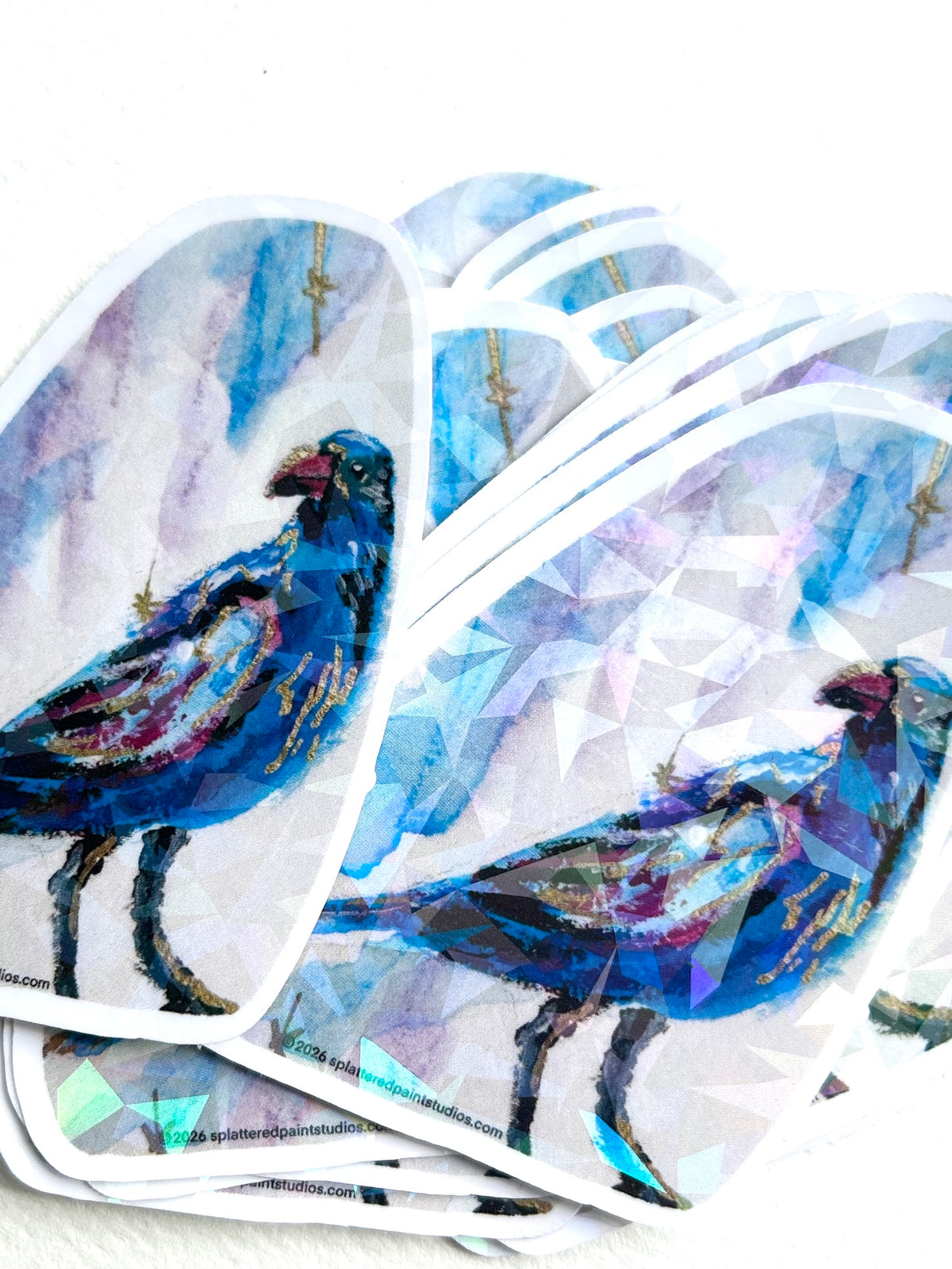 Group of Nightflare holographic vinyl art stickers featuring a vibrant blue bird with reflective geometric accents