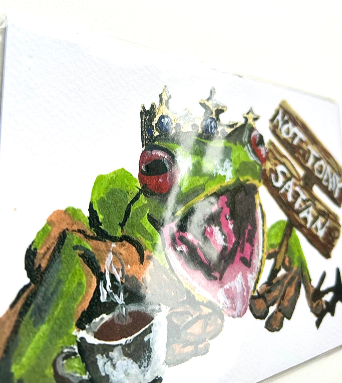 Angled close-up of Not Today Satan 5x7 art print showing the crowned frog, flower, coffee cup, and sign