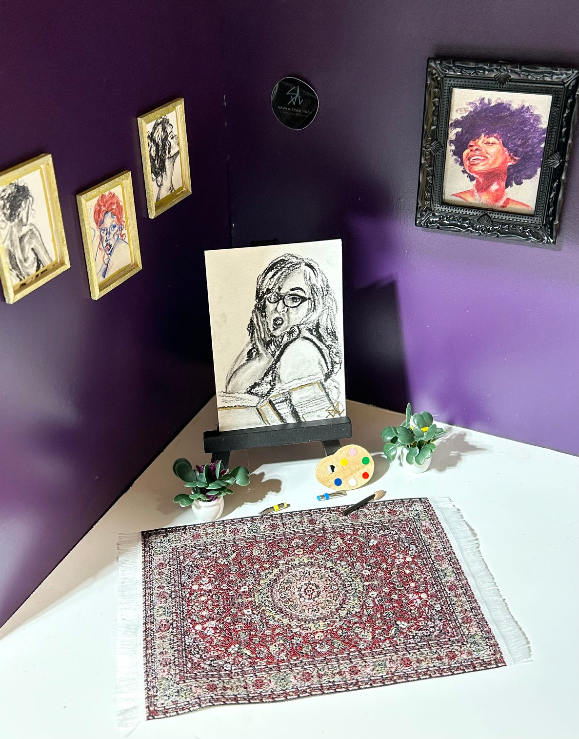 Oh? miniature charcoal portrait displayed in an art room