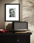Overwhelm 5x7 charcoal art print displayed framed above a guitar and amplifier