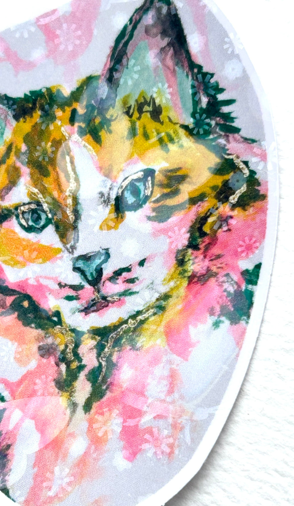 Close-up of Radiant Stillness holographic vinyl sticker featuring a colorful cat in pink, gold, teal, and green