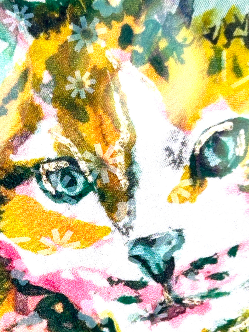 Close-up of Radiant Stillness holographic vinyl sticker showing the colorful cat face in pink, gold, and teal