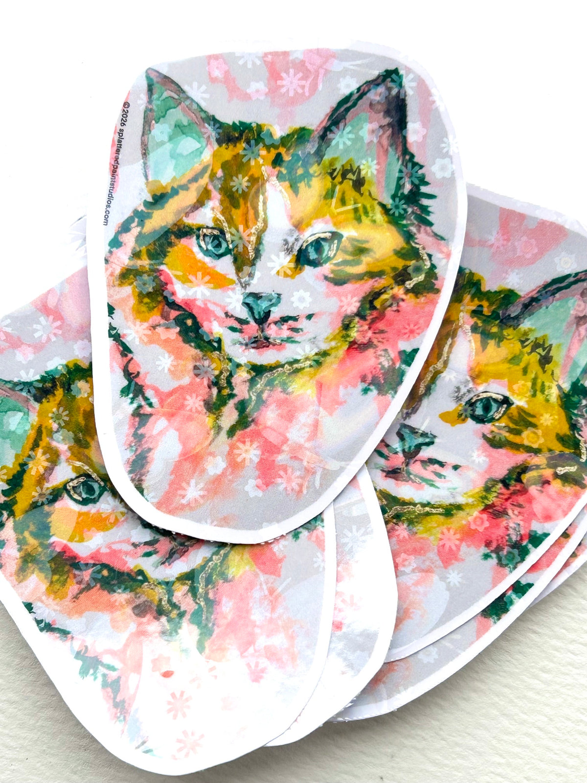 Stack of Radiant Stillness holographic vinyl stickers featuring colorful cat artwork from the Neon Familiars collection