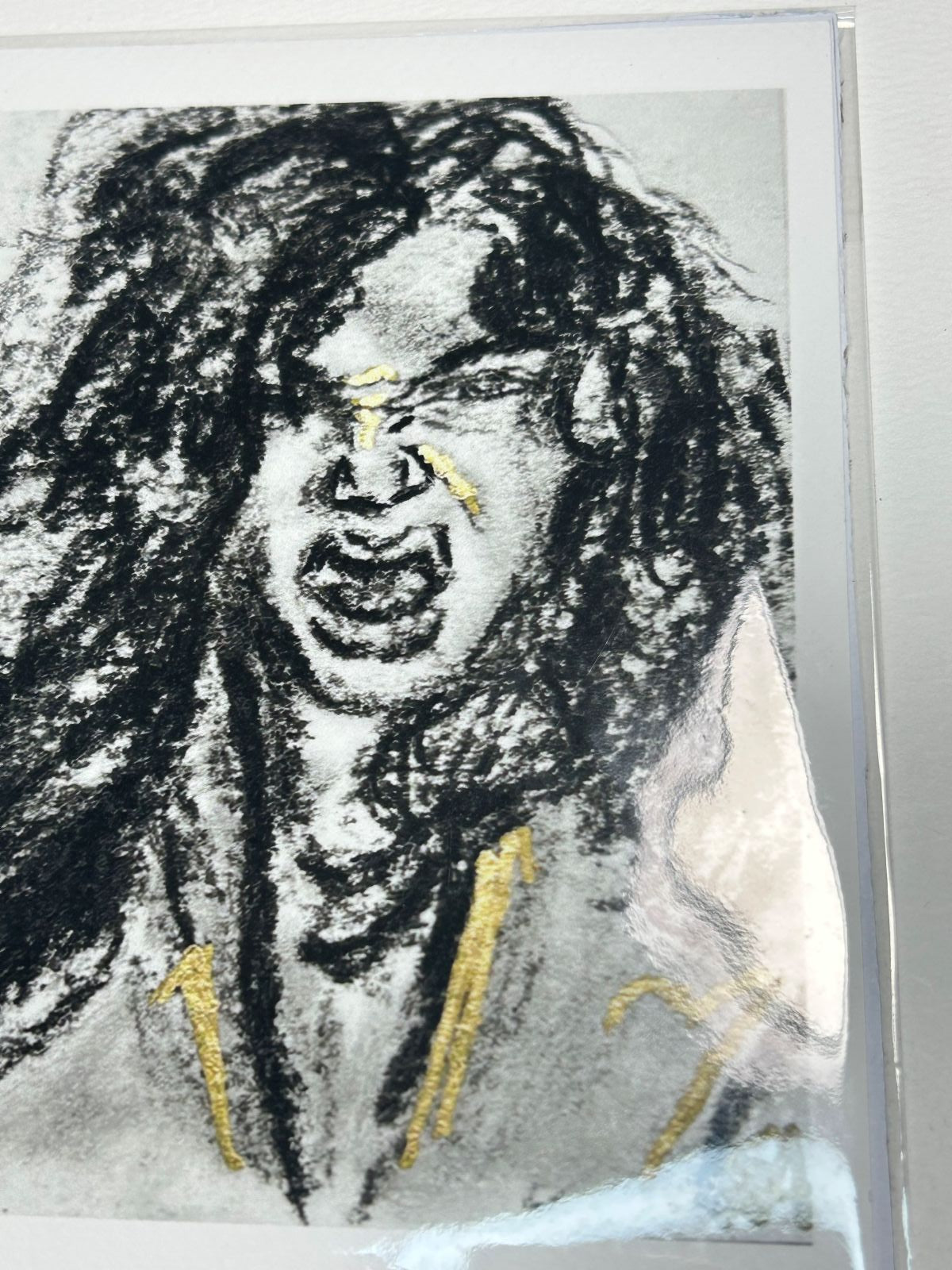 Close-up of Rage Bloom charcoal art print showing an expressive portrait with gold accents