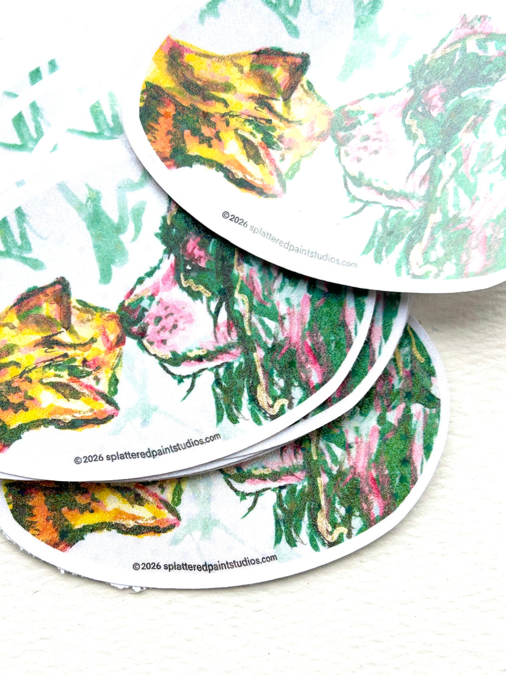 Stack of Recognition holographic vinyl stickers featuring a colorful cat and dog touching noses from the Neon Familiars collection