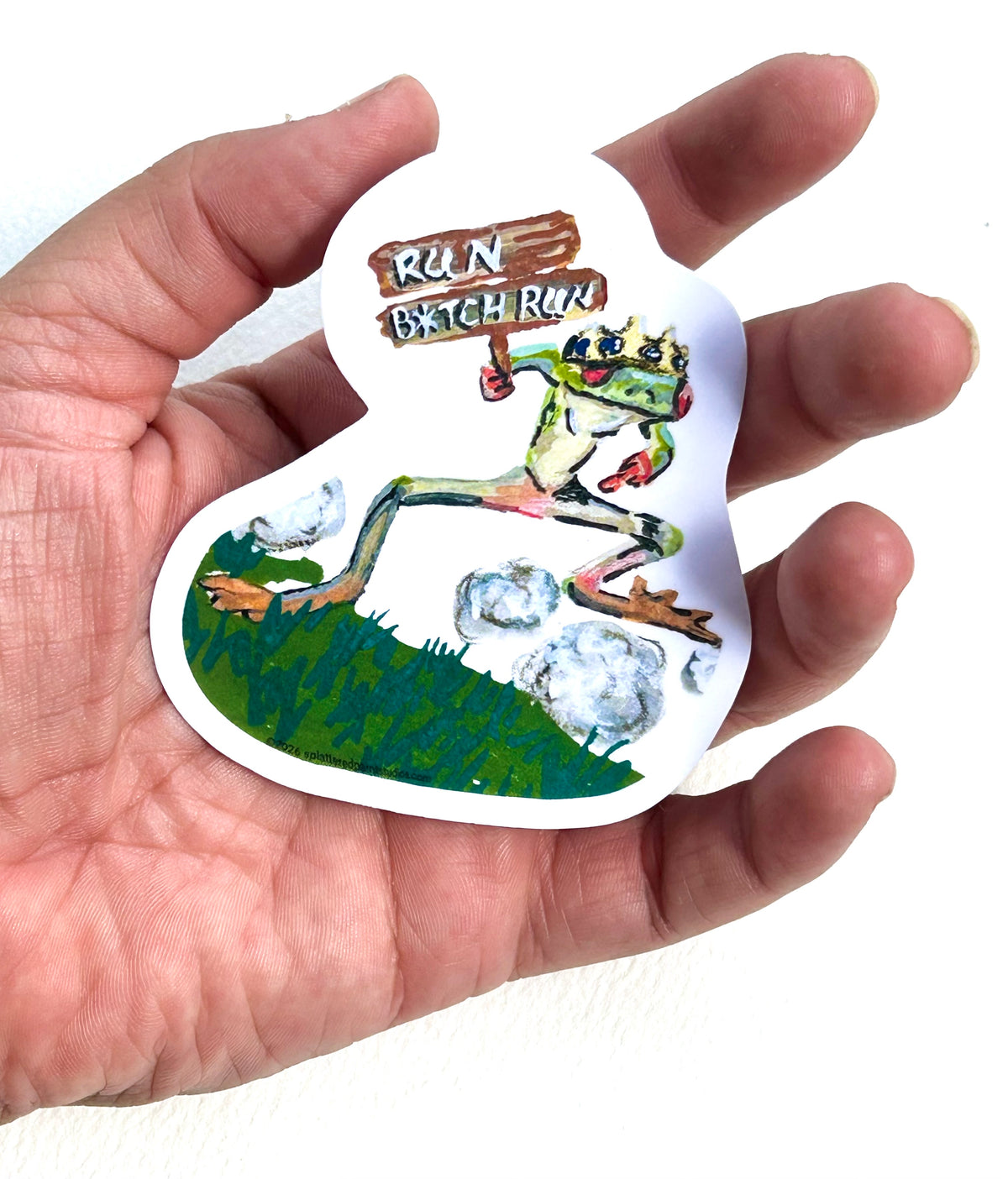 Run B*tch Run 3-inch vinyl sticker held in hand to show size and scale