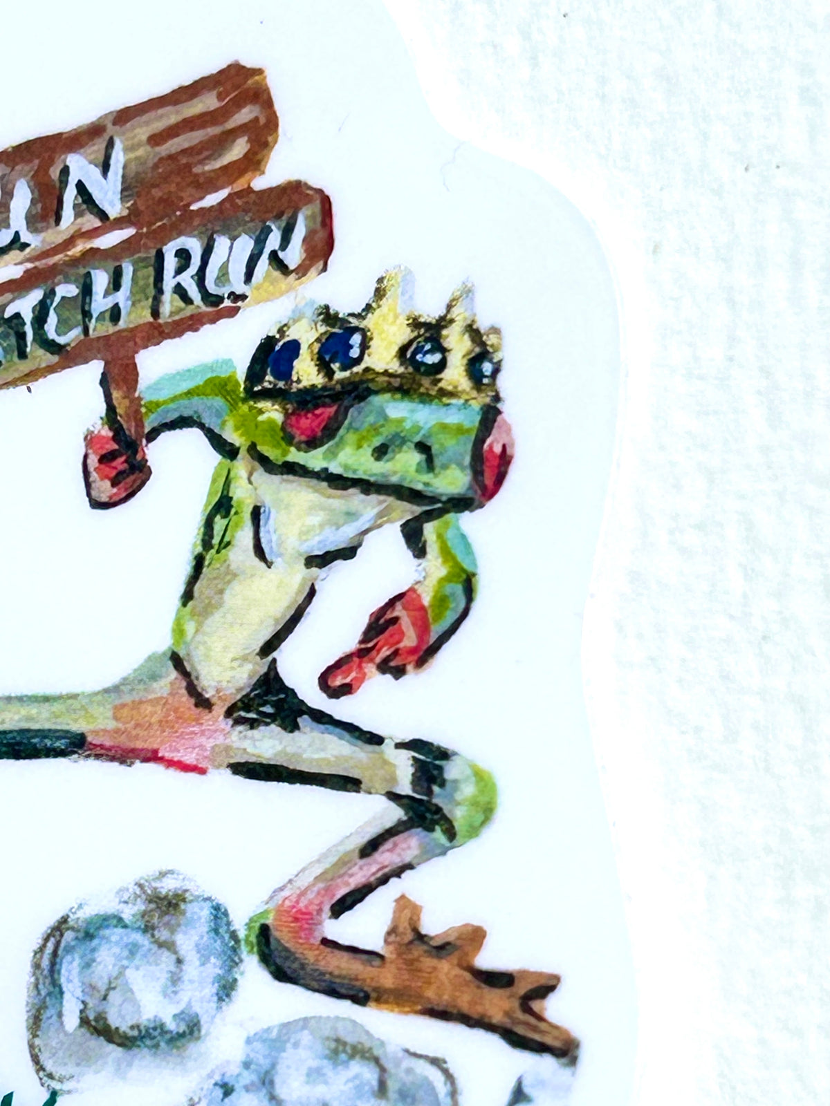 Close-up of Run B*tch Run vinyl sticker showing the crowned frog mid-run with its wooden sign