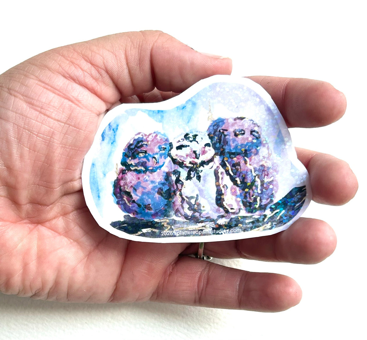 Starbound Siblings 3-inch vinyl art sticker held in hand to show size and scale