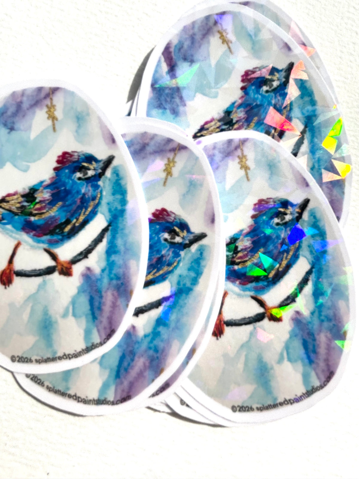 Group of Starglint vinyl art stickers featuring a colorful blue bird with reflective geometric accents