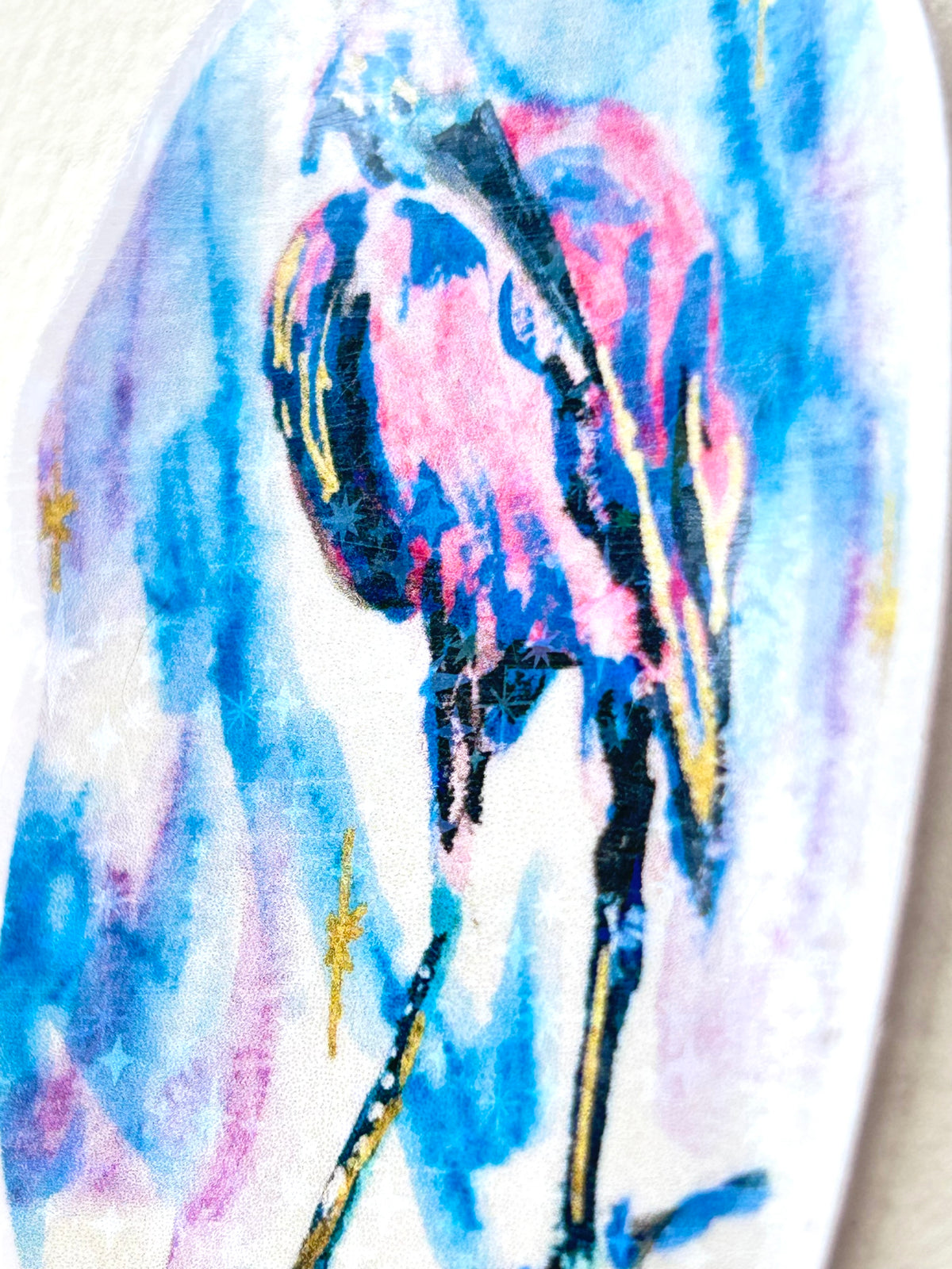 Angled side view of Starwake vinyl sticker showing the pink and blue bird artwork and star details