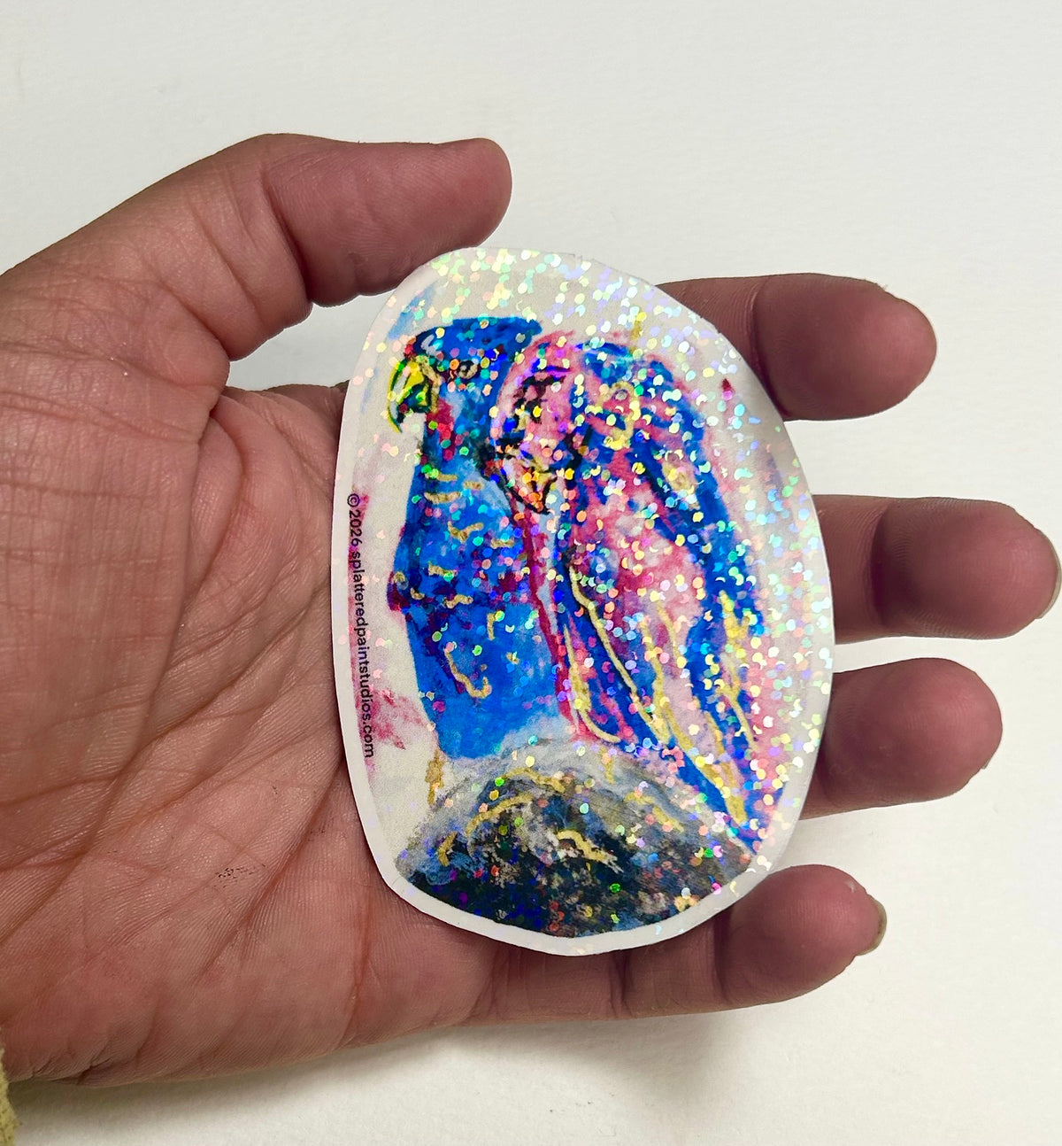 Starwoven 3-inch holographic vinyl sticker held in hand to show size and scale